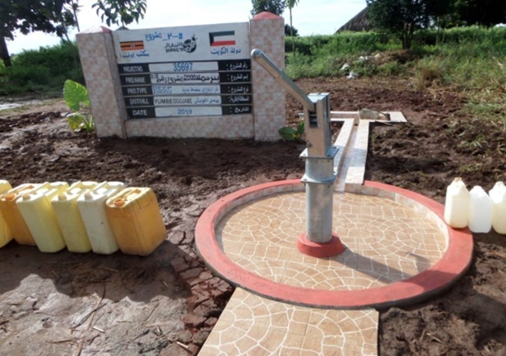 Hand pump borehole on a completed tiled apron with water containers
